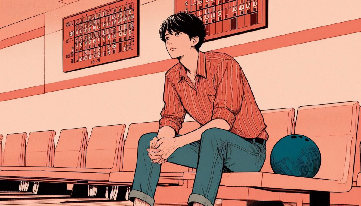 ボウリング場のベンチに座って考え込む若い男性