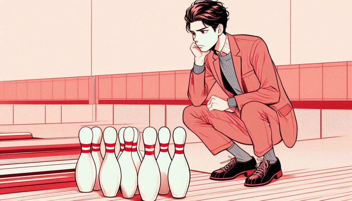 レーンに残ったピンを数える男性